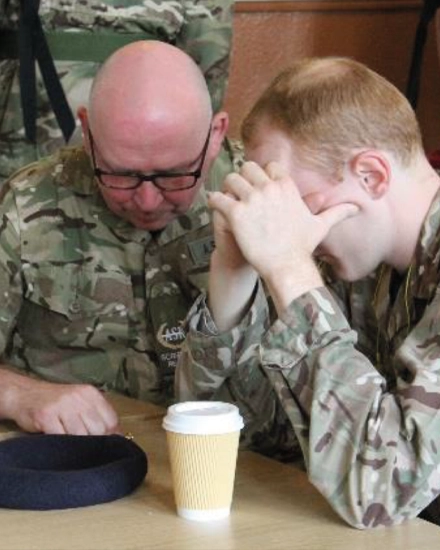 A Scripture Reader praying with a soldier, © SASRA copyright