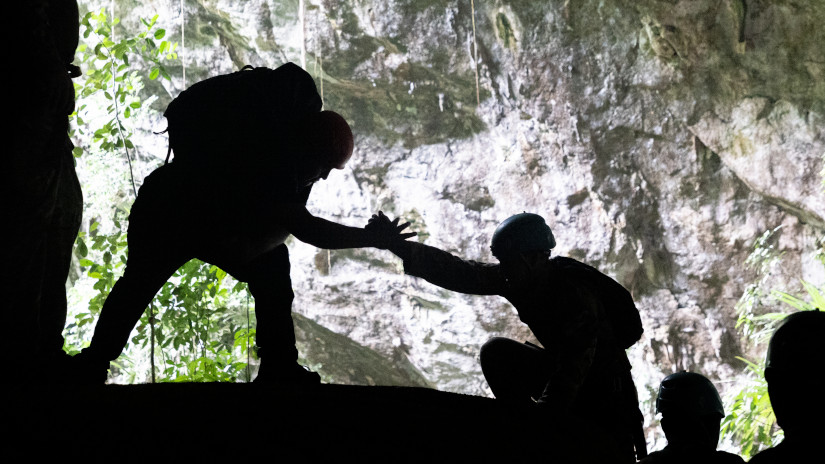 Soldiers help each other to climb inside a cave. UK MOD © Crown copyright 2022