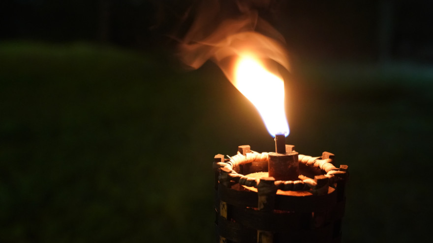 A torch burning in the dark.