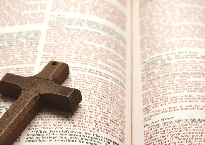 Open Bible with a wooden cross.