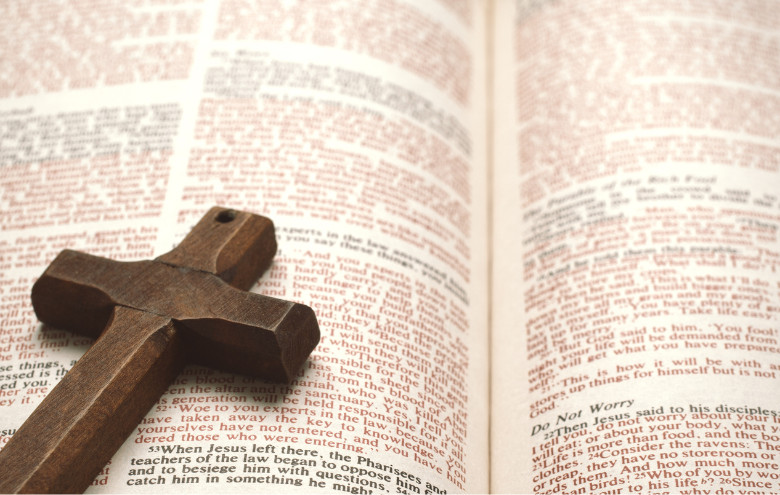 Open Bible with a wooden cross.