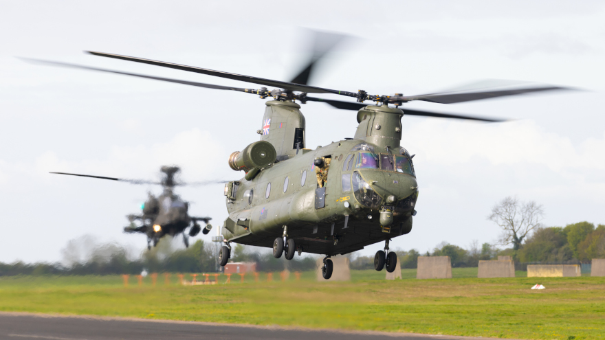 A Chinook helicopter flying in front of an Apache at Wattisham Flying Station. UK MOD © Crown copyright 2024