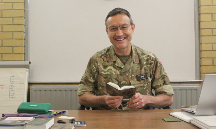ASR Mike Blackstock sitting at a desk with an open Bible.